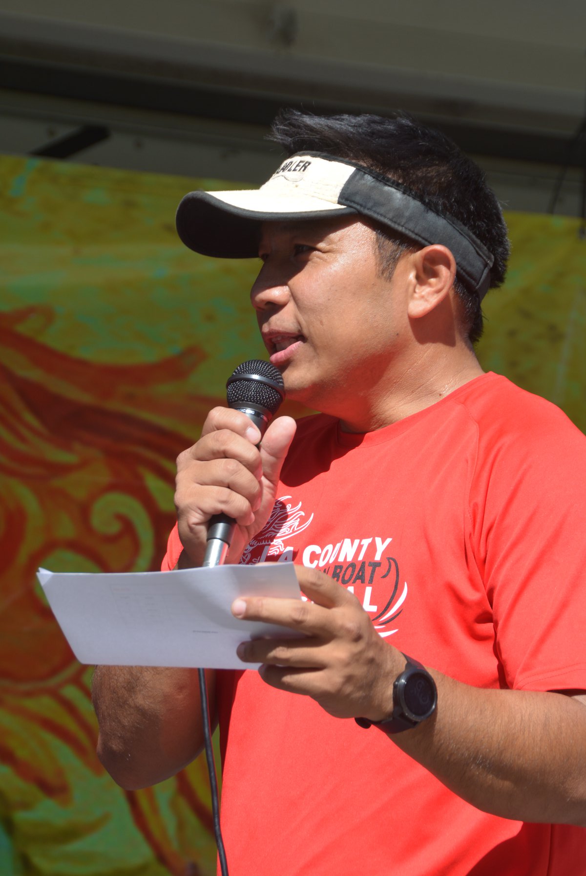 Person holding microphone at Dragon Boat race