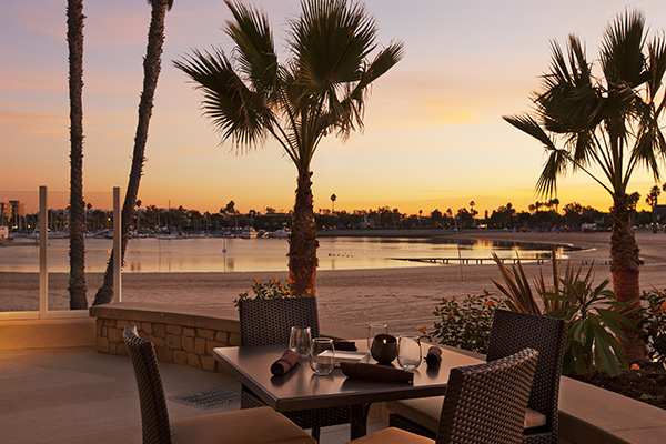 outdoor patio with marina in background at dusk