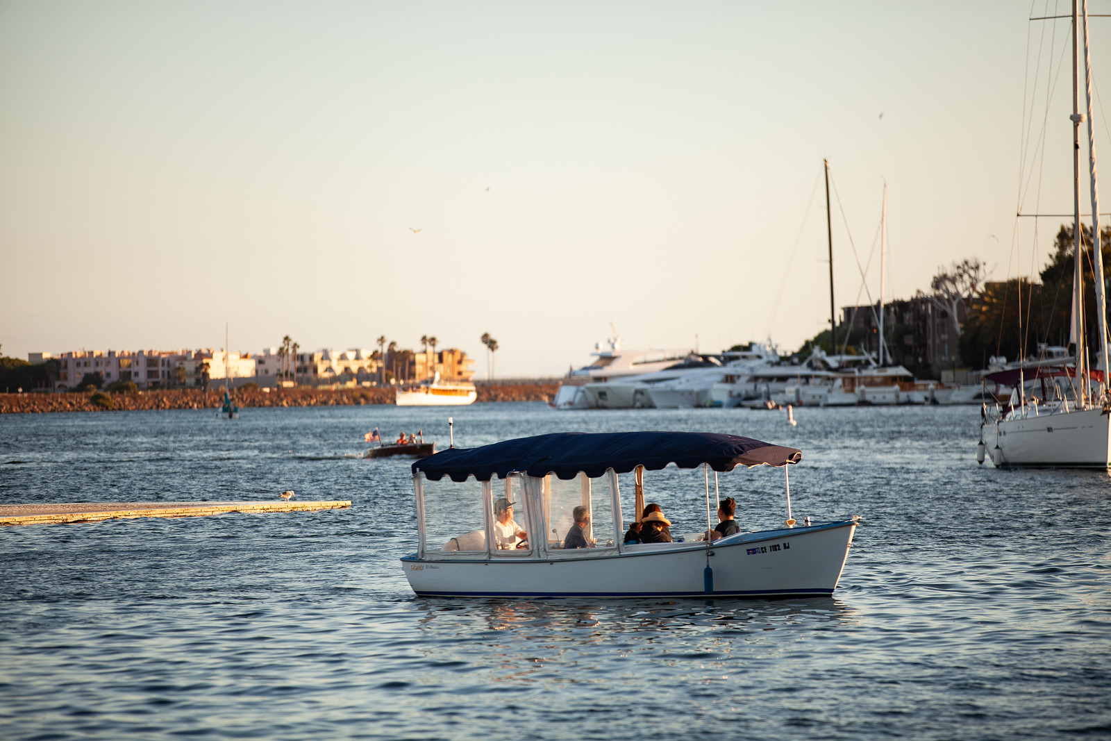 Group inside a duffy boat in Marina del Rey channel, a fall social distancing activity