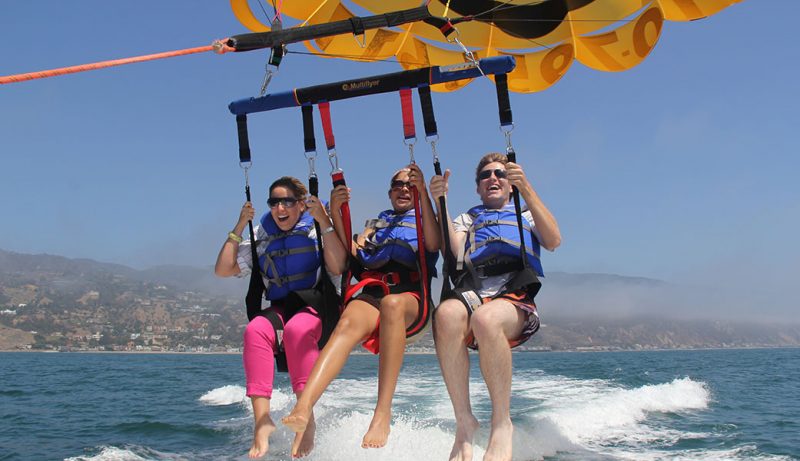 people enjoying parasailing