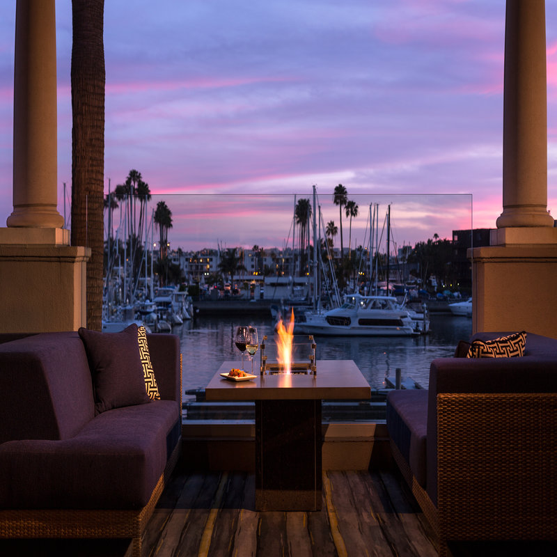 outdoor patio seating at Cast & Plow facing Marina harbor