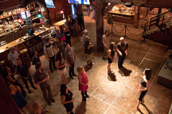 people taking a dance lesson with instructor in front