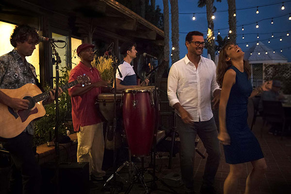 couple dancing in front of band at night