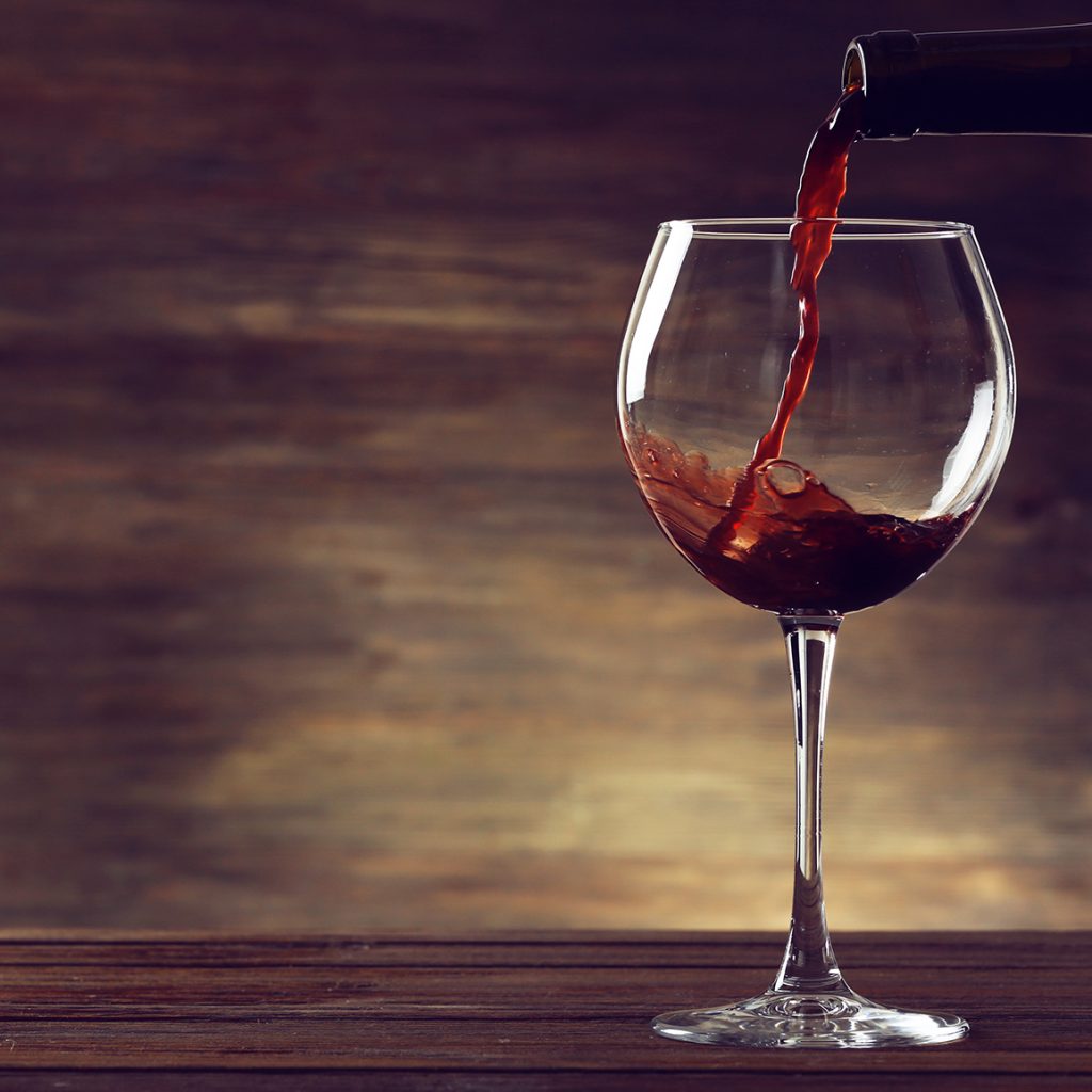 Red wine pouring in a glass