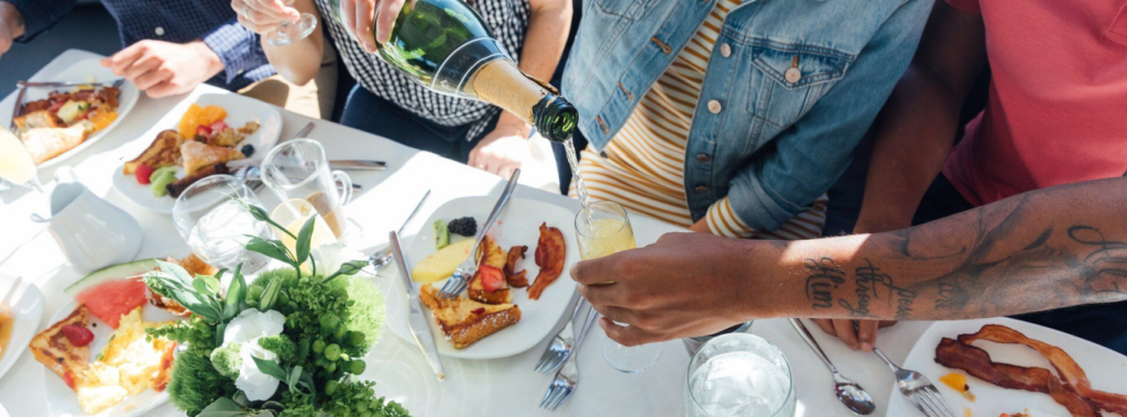 champagne poured into glass during celebration brunch