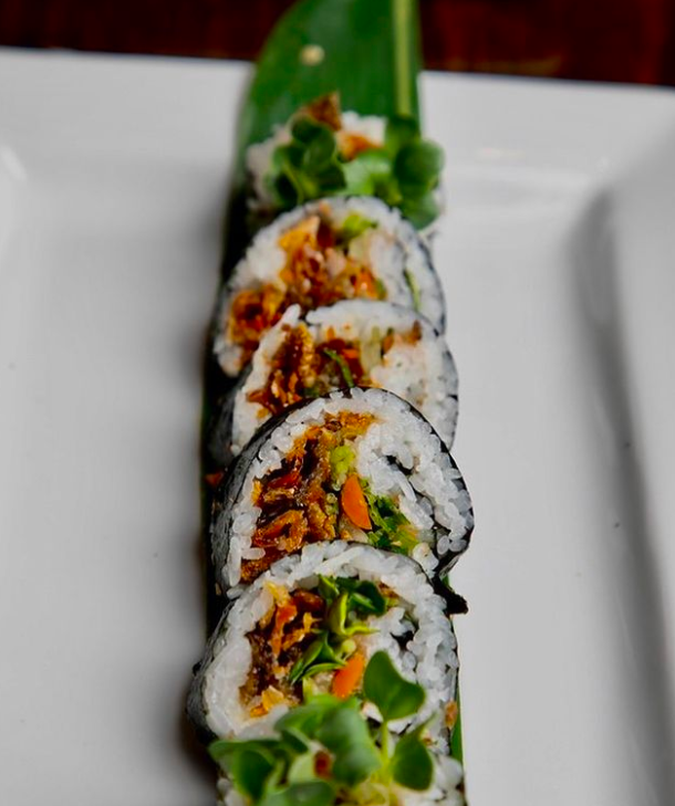 Crispy salmon skin sushi roll on a plate