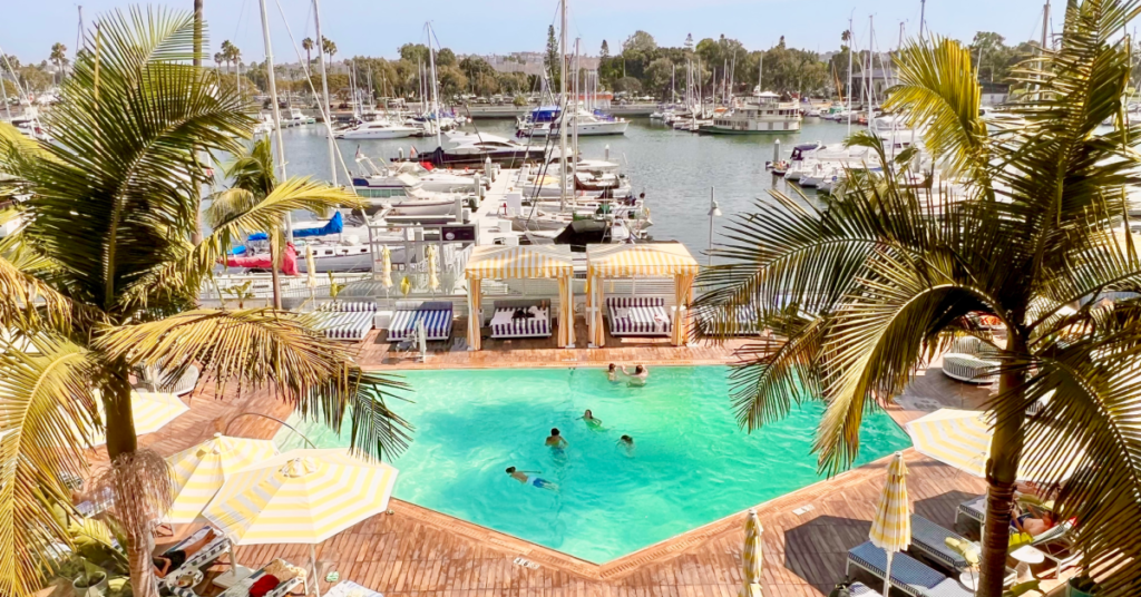 Hotel pool with palm trees and view of marina to plan a trip to Los Angeles